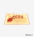 Weihnachtsmann mit Schlitten, Rentieren und Kirche - Kartenfarbe Rot - 15 x 20 cm